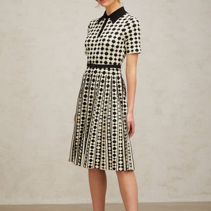 A colorful knit midi dress with polka dot pattern and color block design featuring different sections in contrasting colors