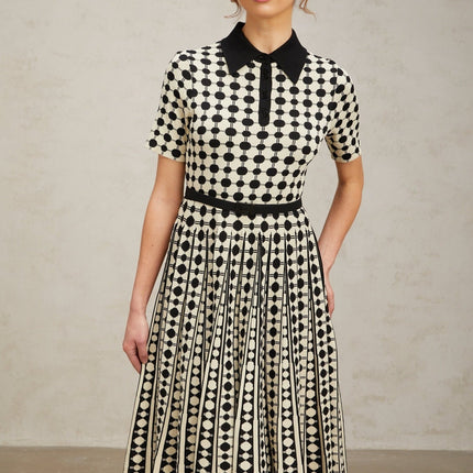 A colorful knit midi dress with polka dot pattern and color blocking design from Xaviere