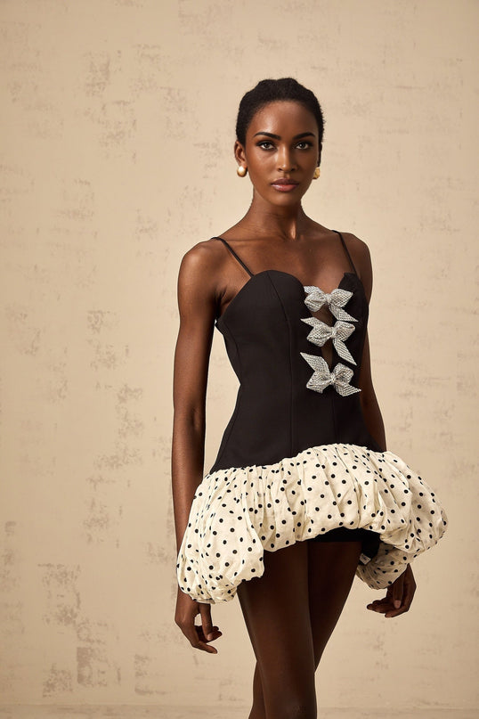 A colorful mini dress with a bowknot detail featuring color blocking and polka dot patterns