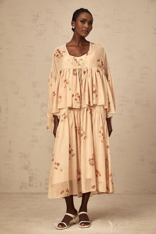 A coralpink floral print matching set featuring a pleated blouse and dress in the Maïa style