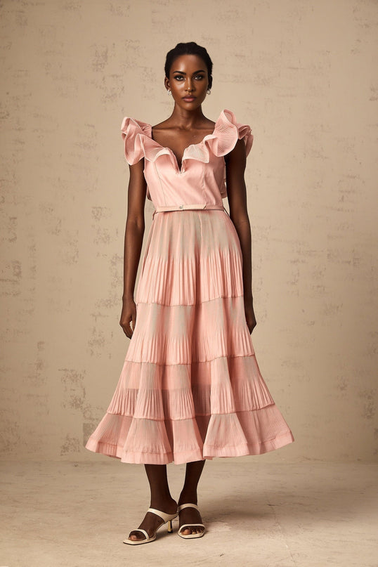 A coralpink midi dress with pleated details and frilly accents named Valentina