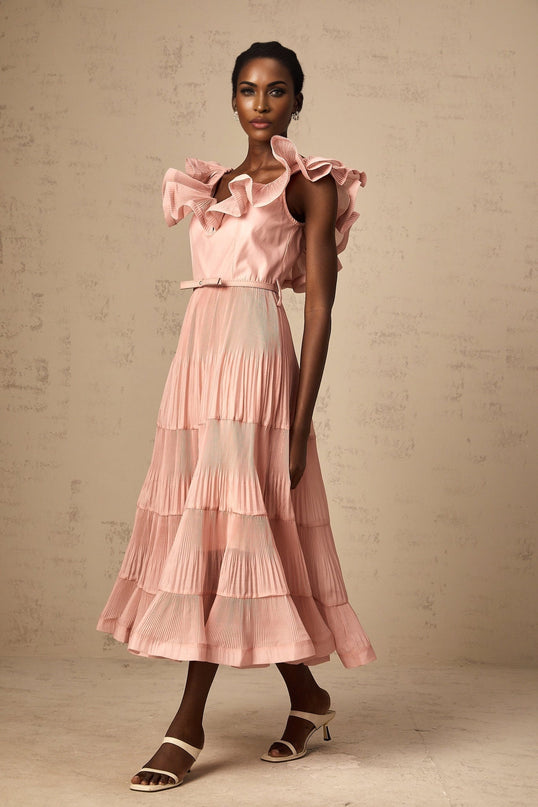 A coralpink midi dress with pleated details and frilly accents named Valentina