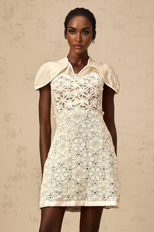 A cream colored mini dress with embroidered details and paneled design named Wilhelmine
