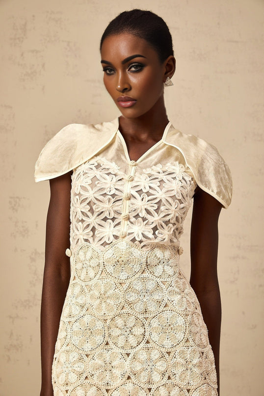 A cream colored mini dress with embroidered panels named Wilhelmine featuring a short hemline and delicate stitching details