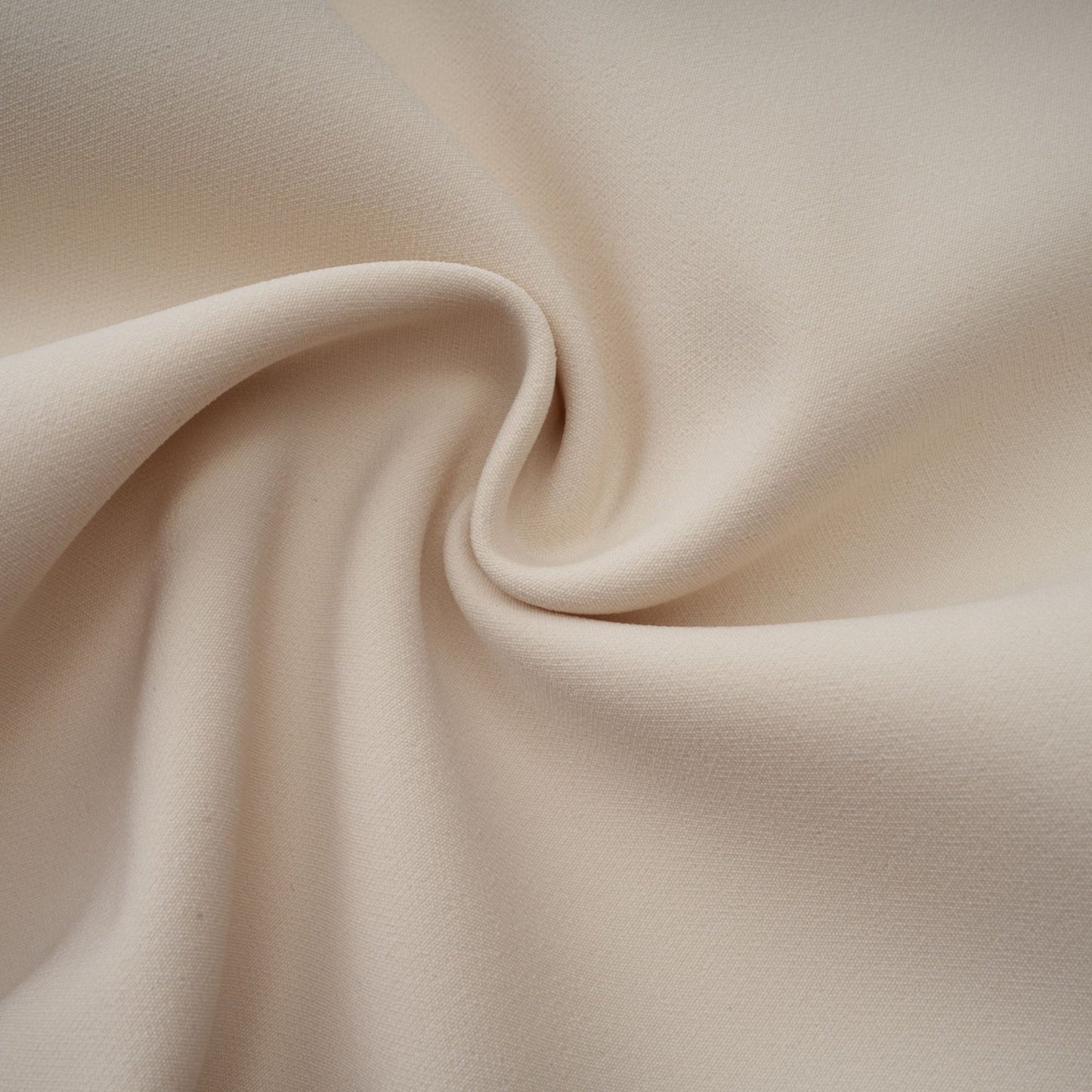 A creamwhite fitted mini dress by Chloé hanging on a plain background showcasing its sleek silhouette and elegant design