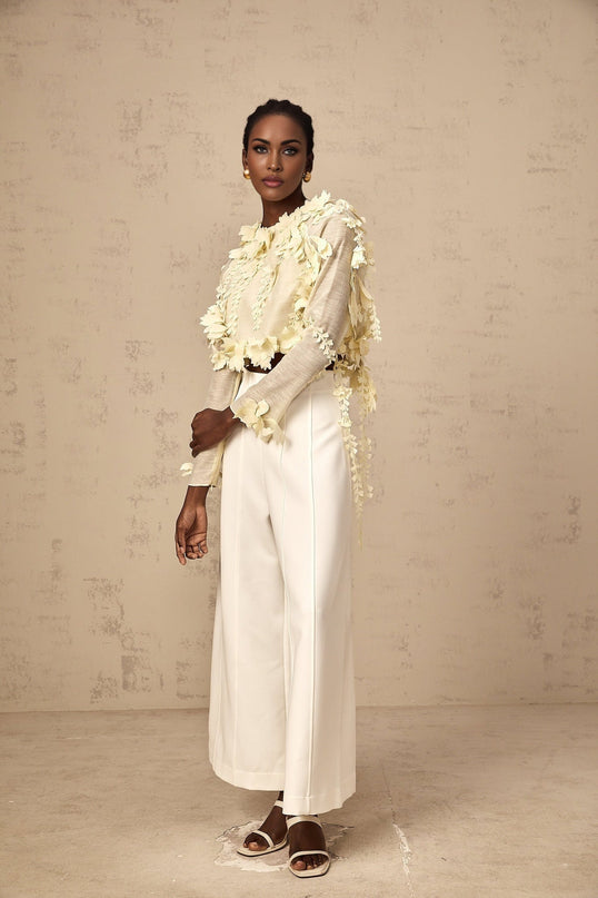 A cropped blouse in light yellow featuring threedimensional petal details named Rosalie