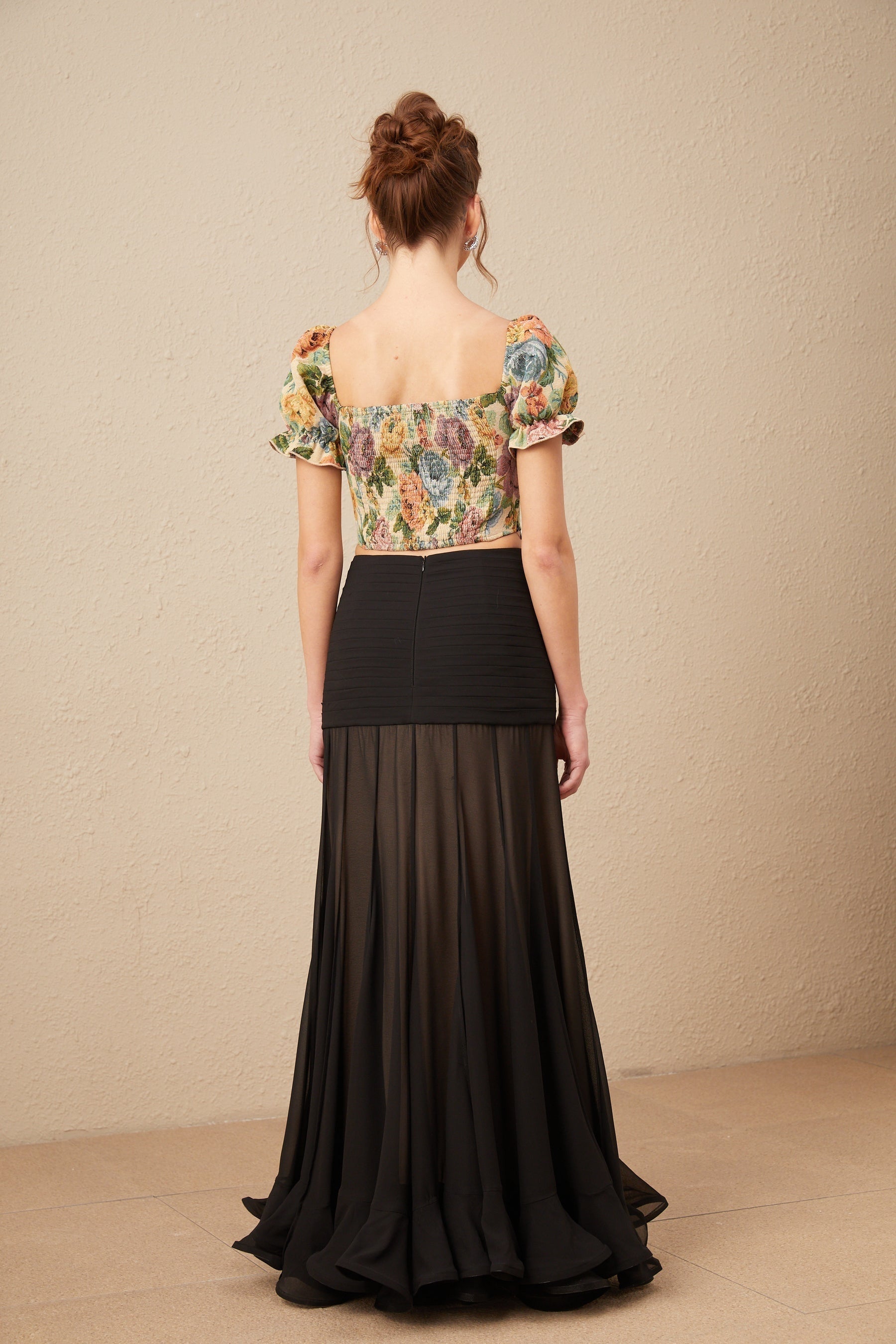 A cropped top with a floral print pattern in jacquard fabric named Constance featuring a colorful design on a textured background