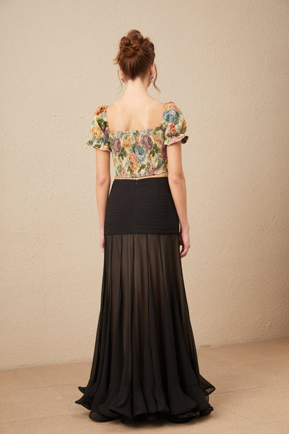 A cropped top with a floral print pattern in jacquard fabric named Constance featuring a colorful design on a textured background