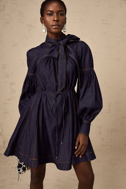 A dark blue denim mini dress with contrasting lightcolored stitching named Mirabel