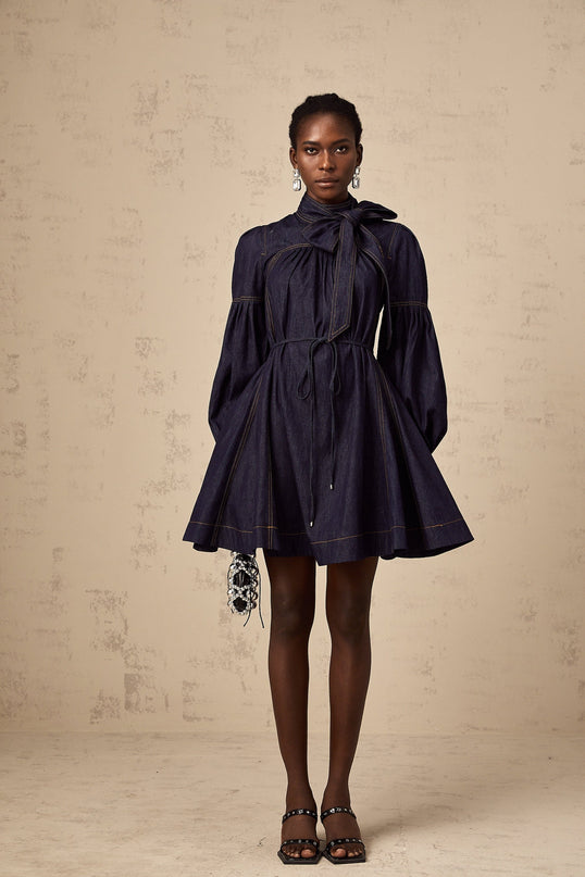 A dark blue denim mini dress with contrasting lightcolored stitching named Mirabel