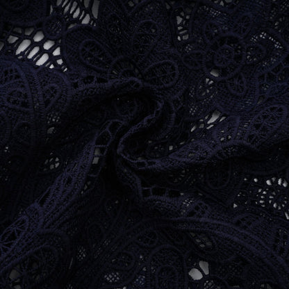 A dark blue midi dress with floral crochet lace pattern and a fitted silhouette