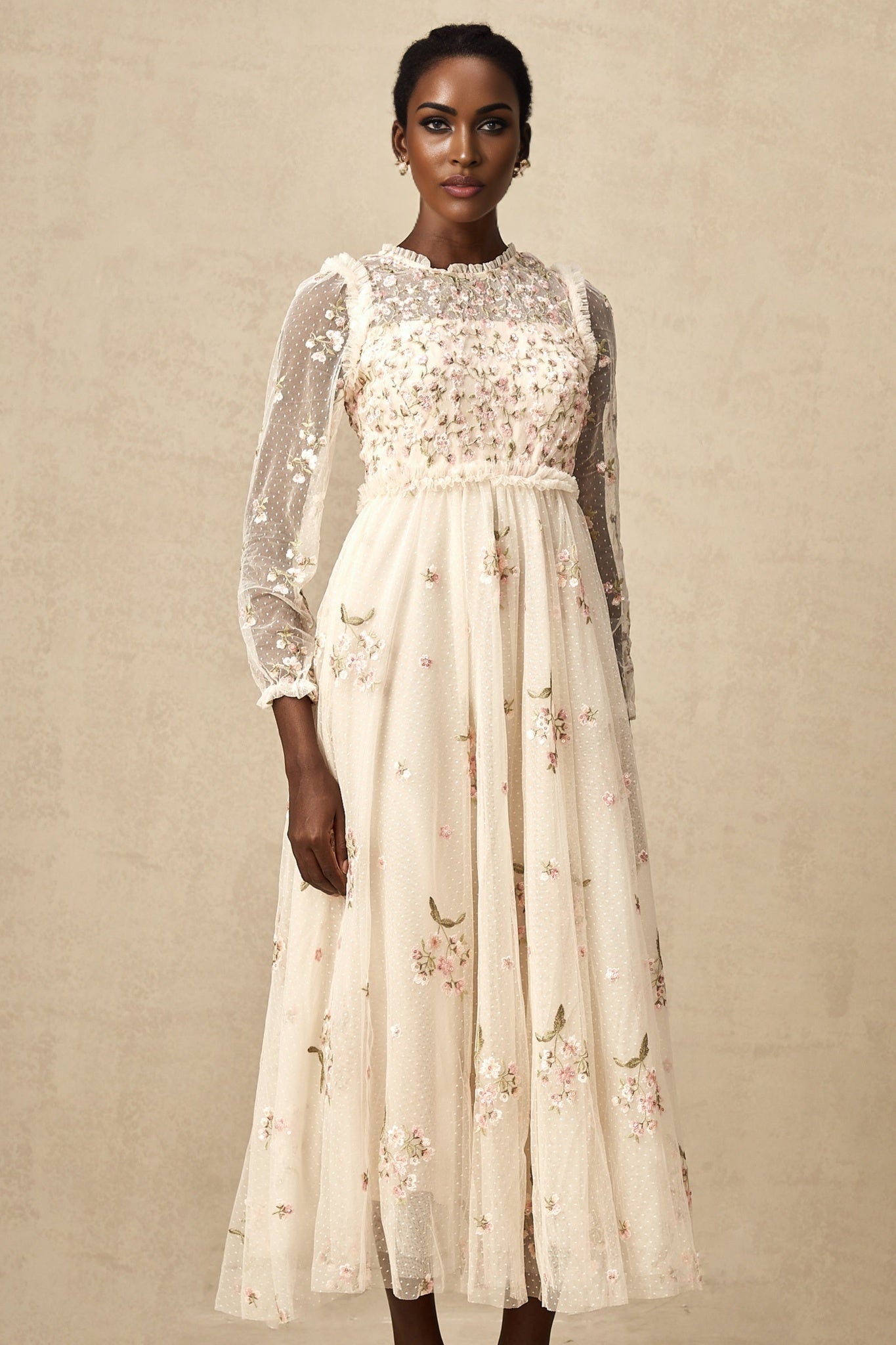 A elegant midi dress with floral embroidery on tulle fabric designed by Celine featuring delicate floral patterns on a sheer overlay