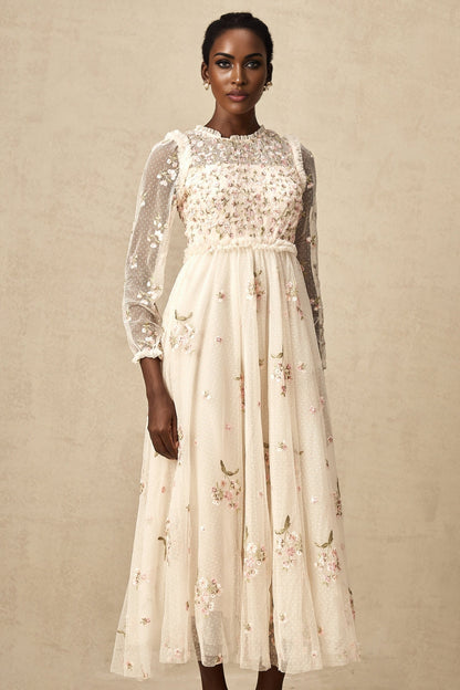 A elegant midi dress with floral embroidery on tulle fabric designed by Celine featuring delicate floral patterns on a sheer overlay