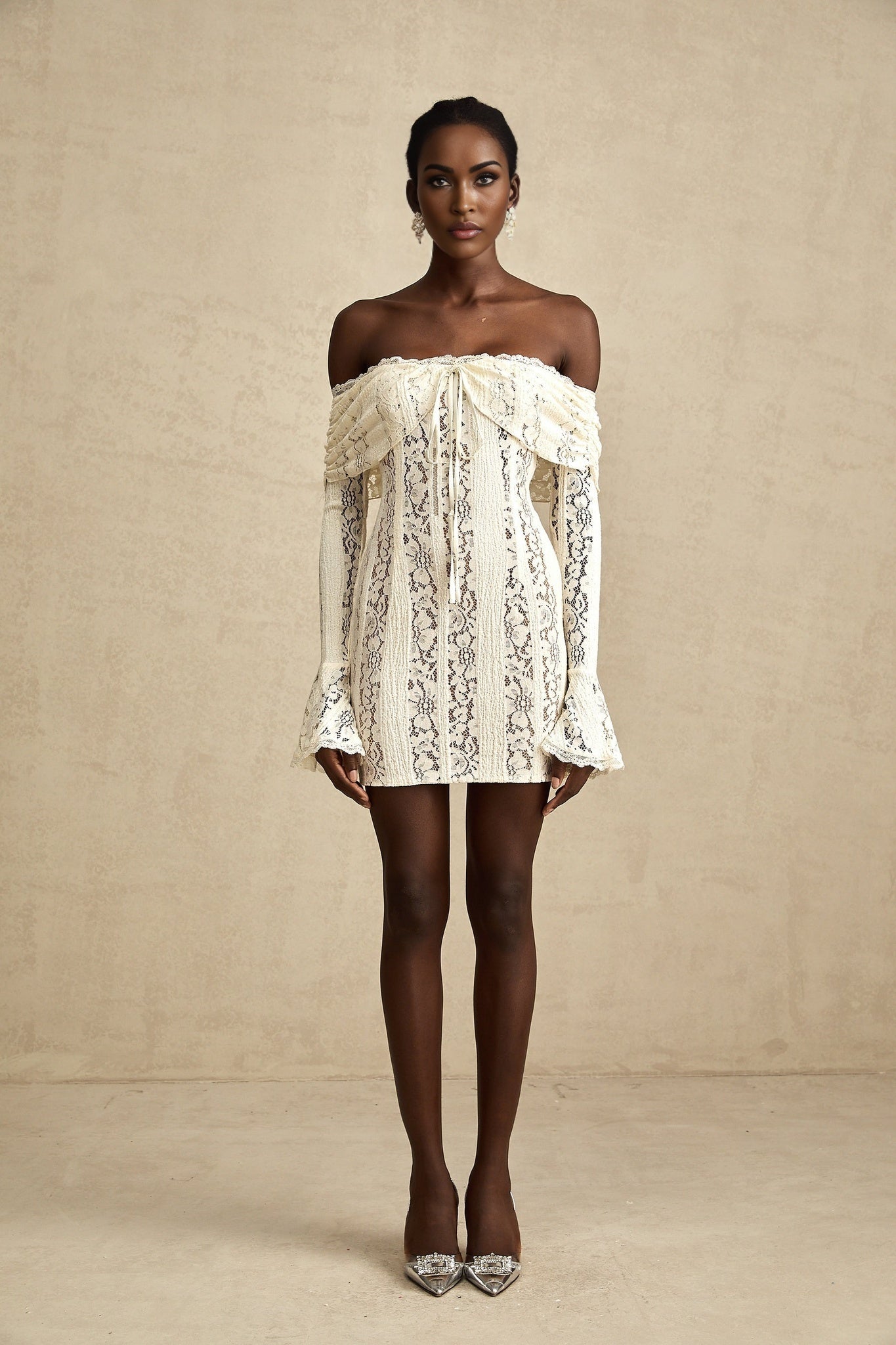 A feminine floral lace mini dress in neutral tones with flared cuffs named Emeline