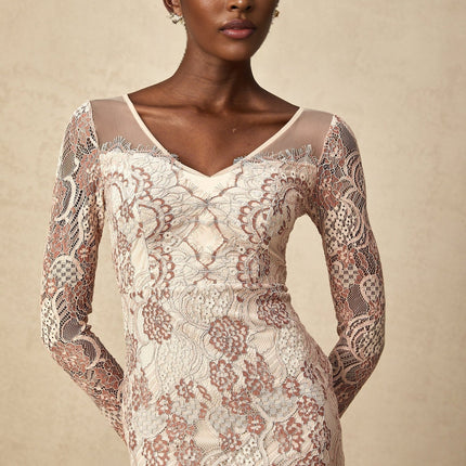 A fitted midi dress in white guipure lace with intricate floral patterns featuring a high neckline and short sleeves