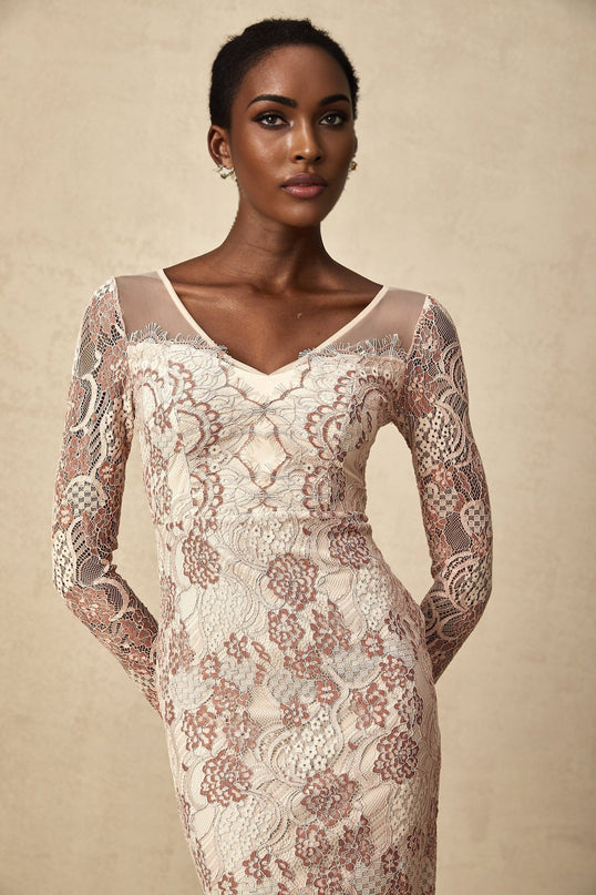 A fitted midi dress in white guipure lace with intricate floral patterns featuring a high neckline and short sleeves