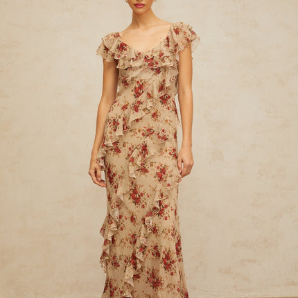 A flared maxi dress with a floral print pattern and ruffled details flowing from top to bottom