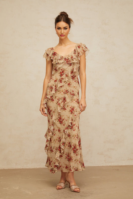 A flared maxi dress with a floral print pattern and ruffled details flowing from top to bottom