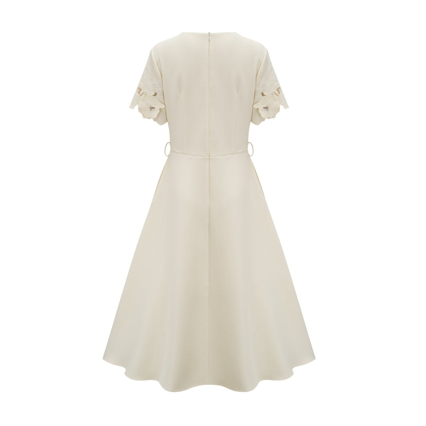 A flared midi dress in neutral tones featuring floral appliqué details with a touch of orange