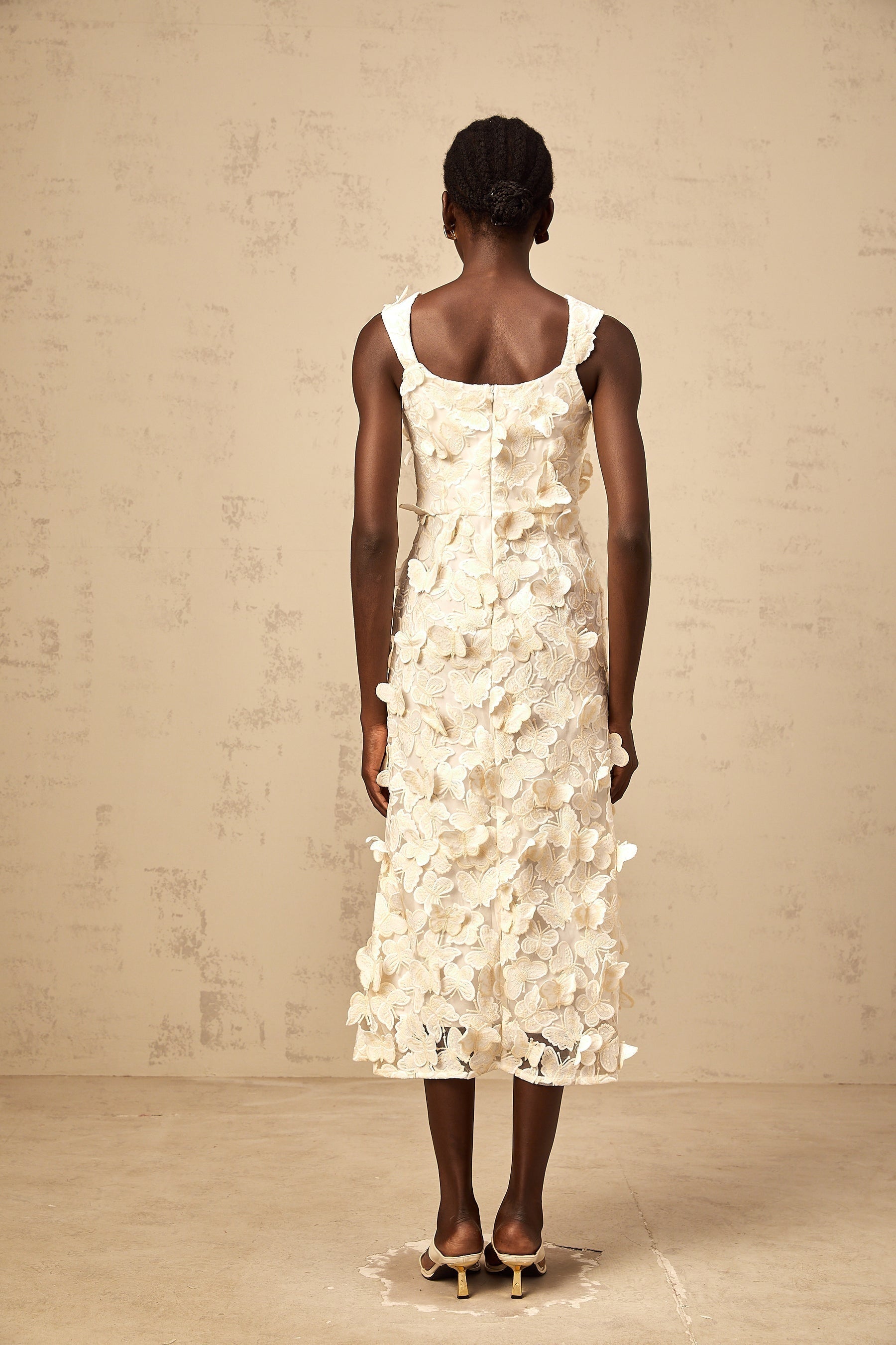 A flared midi dress with butterfly appliques featuring a Narcisse design