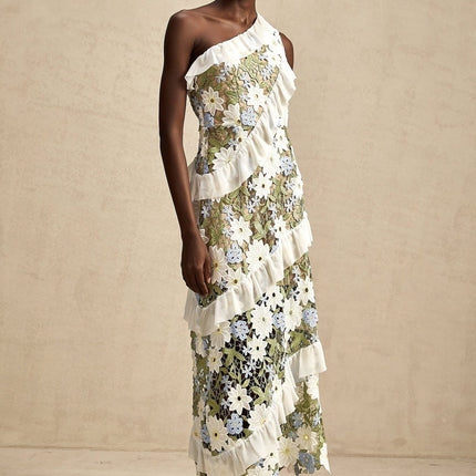 A floral embroidered midi dress in a light color with a feminine silhouette and delicate flower pattern