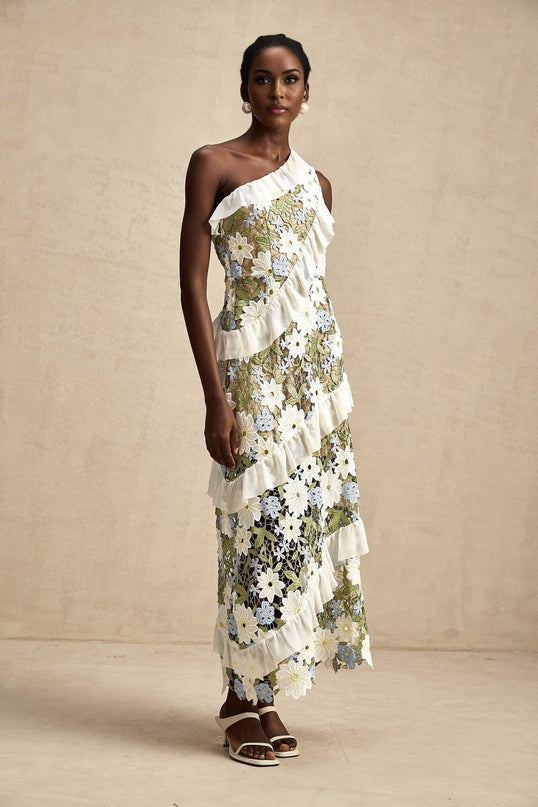 A floral embroidered midi dress in a light color with a feminine silhouette and delicate flower pattern