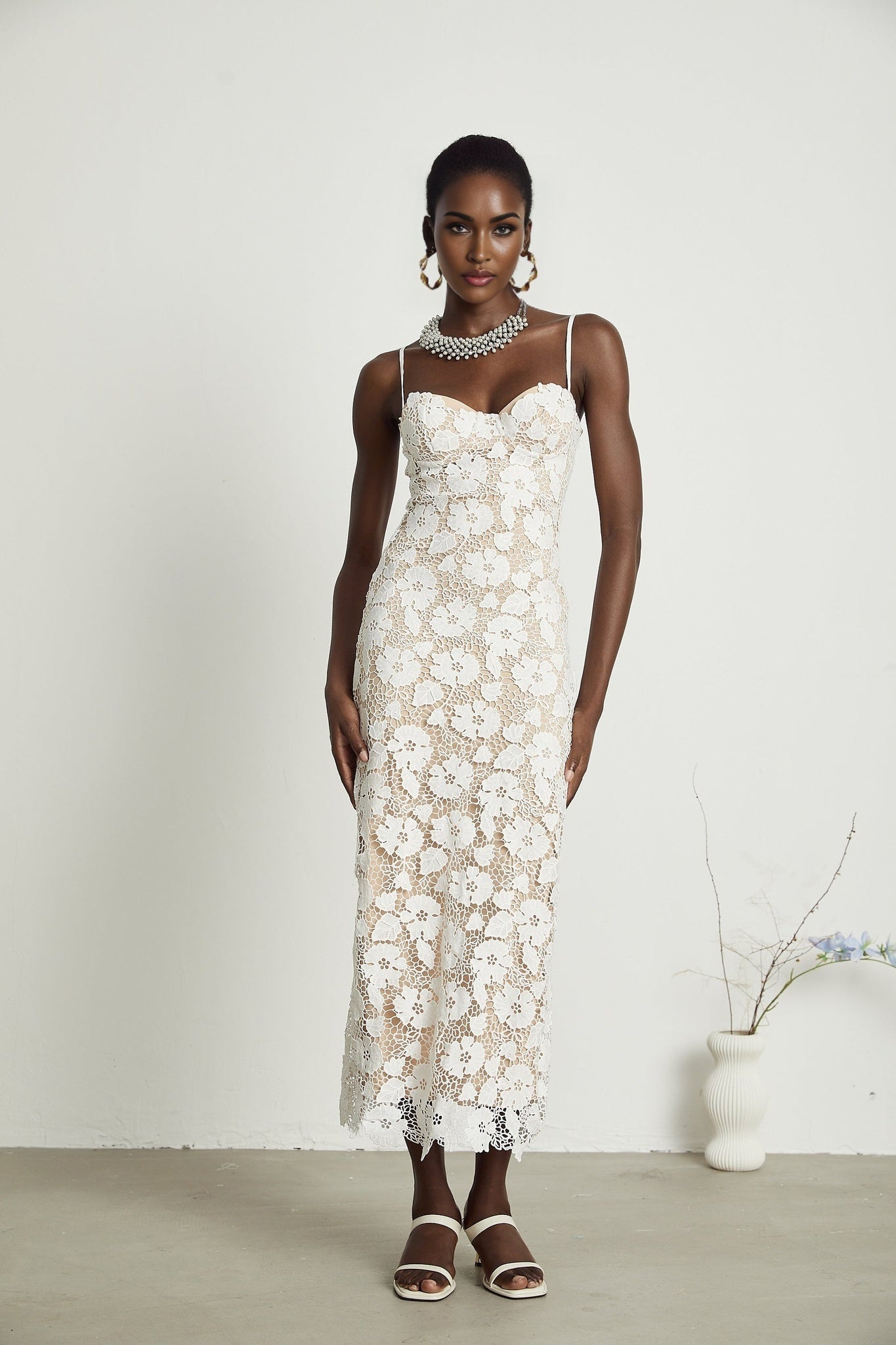 A floral embroidered midi dress in Florence style with a flowing silhouette and delicate floral stitching on the fabric
