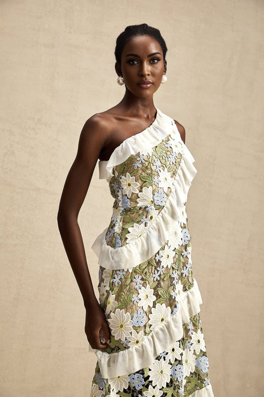 A floral embroidered midi dress named Clemence with a delicate pattern and feminine silhouette