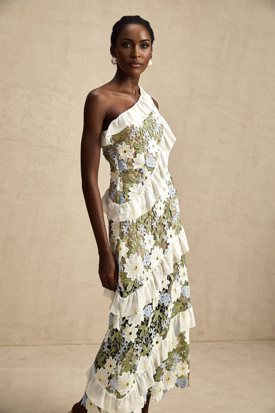 A floral embroidered midi dress named Clemence with a delicate pattern on a light colored fabric