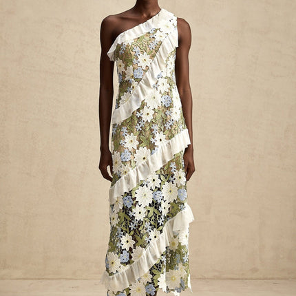 A floral embroidered midi dress named Clémence with a delicate pattern on a light colored fabric