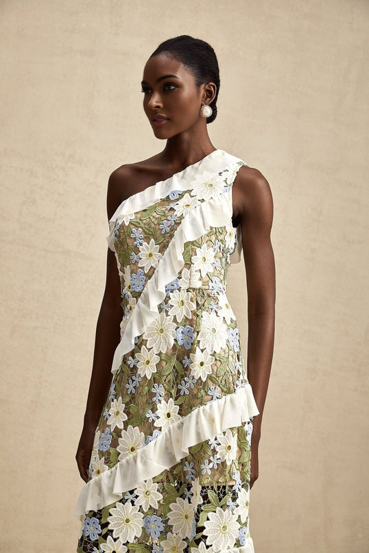 A floral embroidered midi dress with the name Clemence featuring delicate floral patterns on a light fabric background