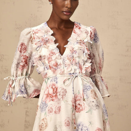 A floral midi dress with a 3d petal print design featuring a tea inspired pattern