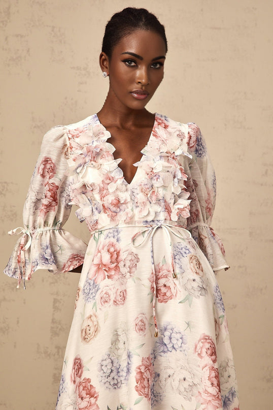 A floral midi dress with a 3d petal print design featuring a tea inspired pattern