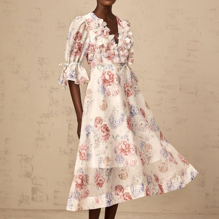 A floral midi dress with a 3d petal print design featuring a vibrant pattern on a flowing silhouette