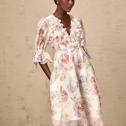A floral midi dress with a 3d petal print pattern and tea colored background