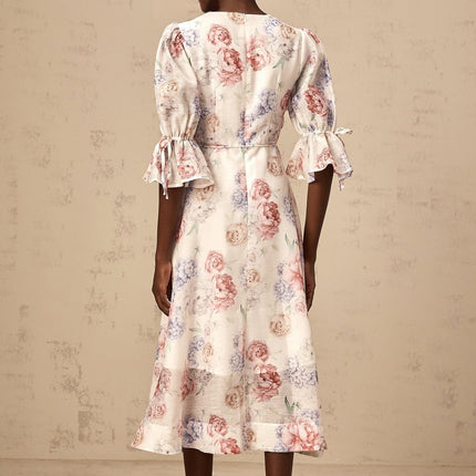 A floral midi dress with a 3d petal print pattern named Tea featuring a vibrant and dimensional floral design on the fabric