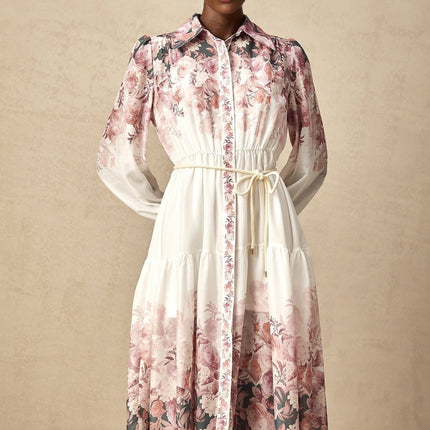 A floral patterned midi dress with lantern sleeves and a design inspired by the Carina style featuring a vibrant print on a light background