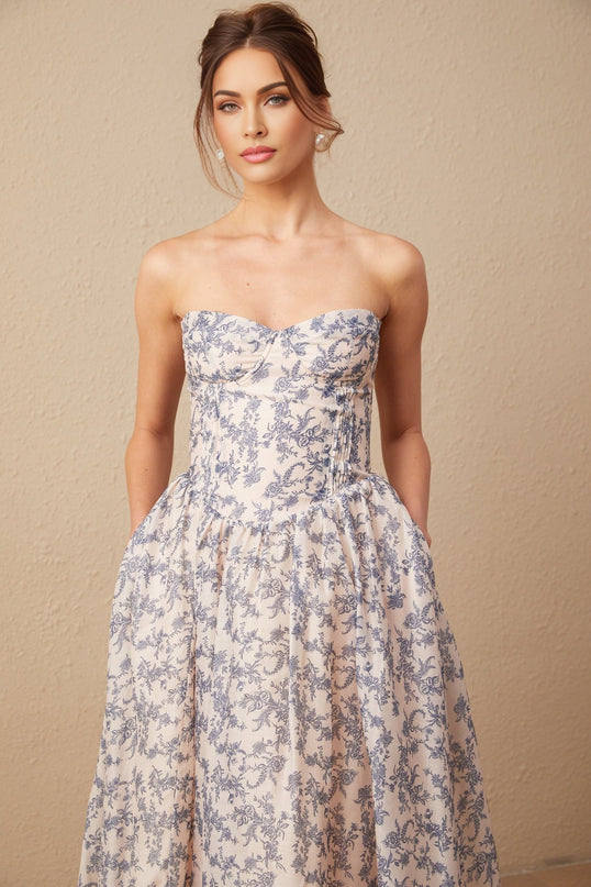 A floral patterned offshoulder midi dress with a fitted bodice and flared skirt in pastel colors