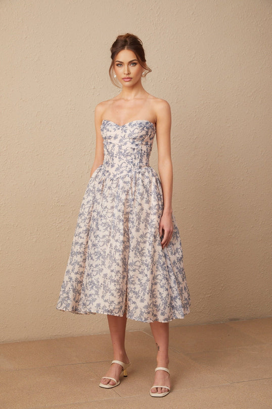 A floral patterned offshoulder midi dress with a fitted waist and flowing skirt