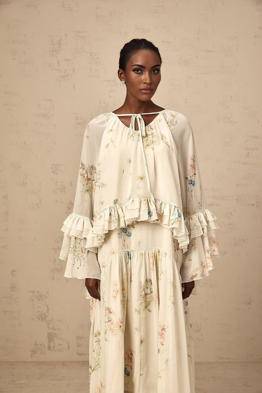 A floral print blouse and dress set with ruffles featuring a Melissa design pattern the blouse and dress have matching fabric and style