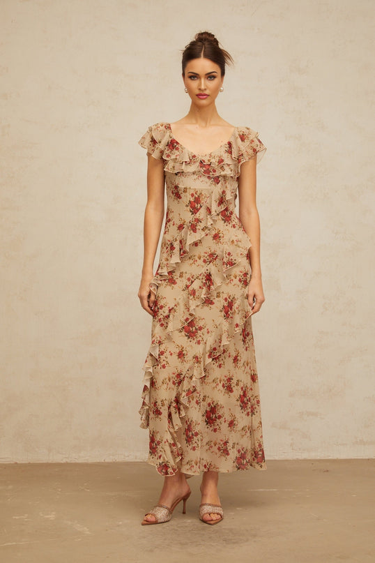 A floral print maxi dress with ruffled details and a flared silhouette in a long flowing style