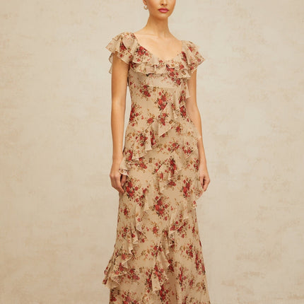 A floral print maxi dress with ruffles and a flared silhouette featuring a long flowing skirt and colorful floral pattern on the fabric
