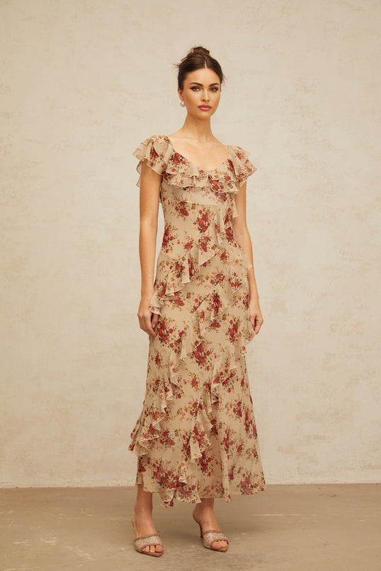 A floral print maxi dress with ruffles and a flared silhouette featuring a long flowing skirt and colorful floral pattern on the fabric