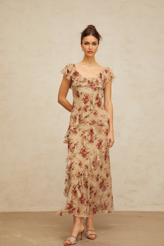 A floral print maxi dress with ruffles and a flared silhouette featuring a long flowing skirt and vibrant floral pattern