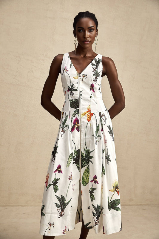 A floral print midi dress with a vneck and poplin fabric featuring a colorful Magali design on a light background