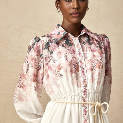 A floral print midi dress with lantern sleeves called Carina featuring a vibrant pattern and flowing silhouette