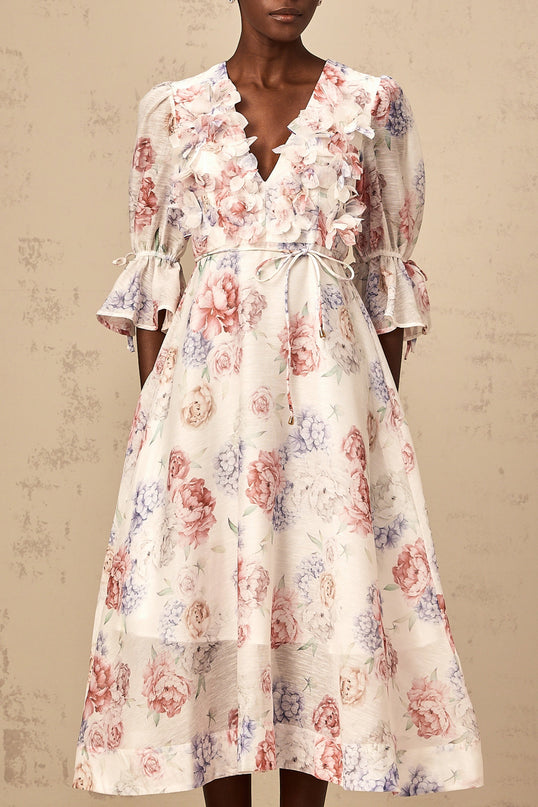 A floral print midi dress with three dimensional petal details featuring a Téa design