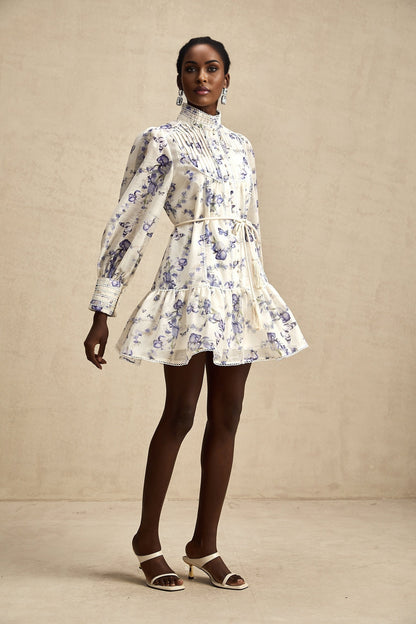 A floral print mini dress with a flared silhouette made from chiffon fabric featuring a colorful pattern on a light background with short sleeves and a flowing skirt