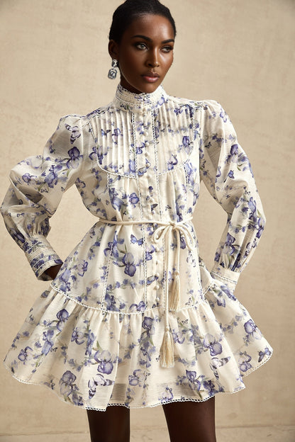 A floral print mini dress with a flared skirt made from chiffon fabric The dress features a vibrant floral pattern and has a short length with a flowy silhouette