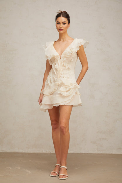 A floral print mini dress with layered ruffles and a faux flower design